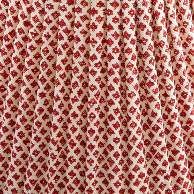 Close-up of a shade with red and white patterned fabric