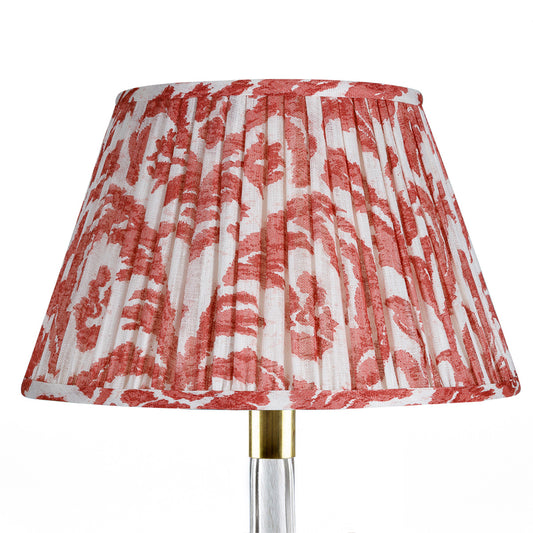 Red and white patterned lampshade on a white background