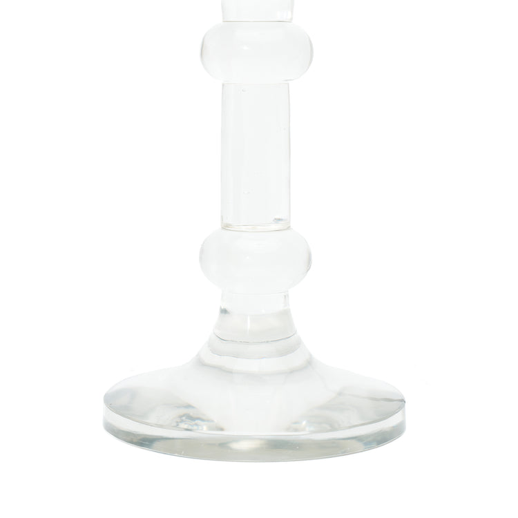 A close-up of a table lamp base, featuring a clear glass base and a clear glass stem, shown against a plain white background.