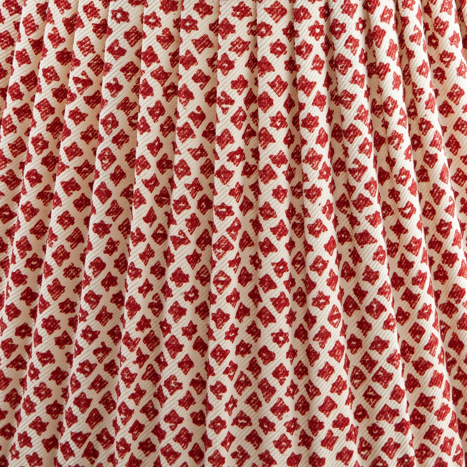 Close-up of a shade with red and white patterned fabric