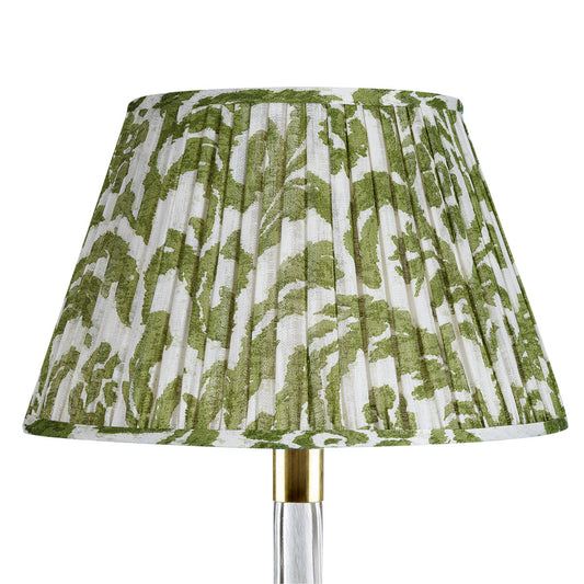 Green and white patterned lampshade on a white background