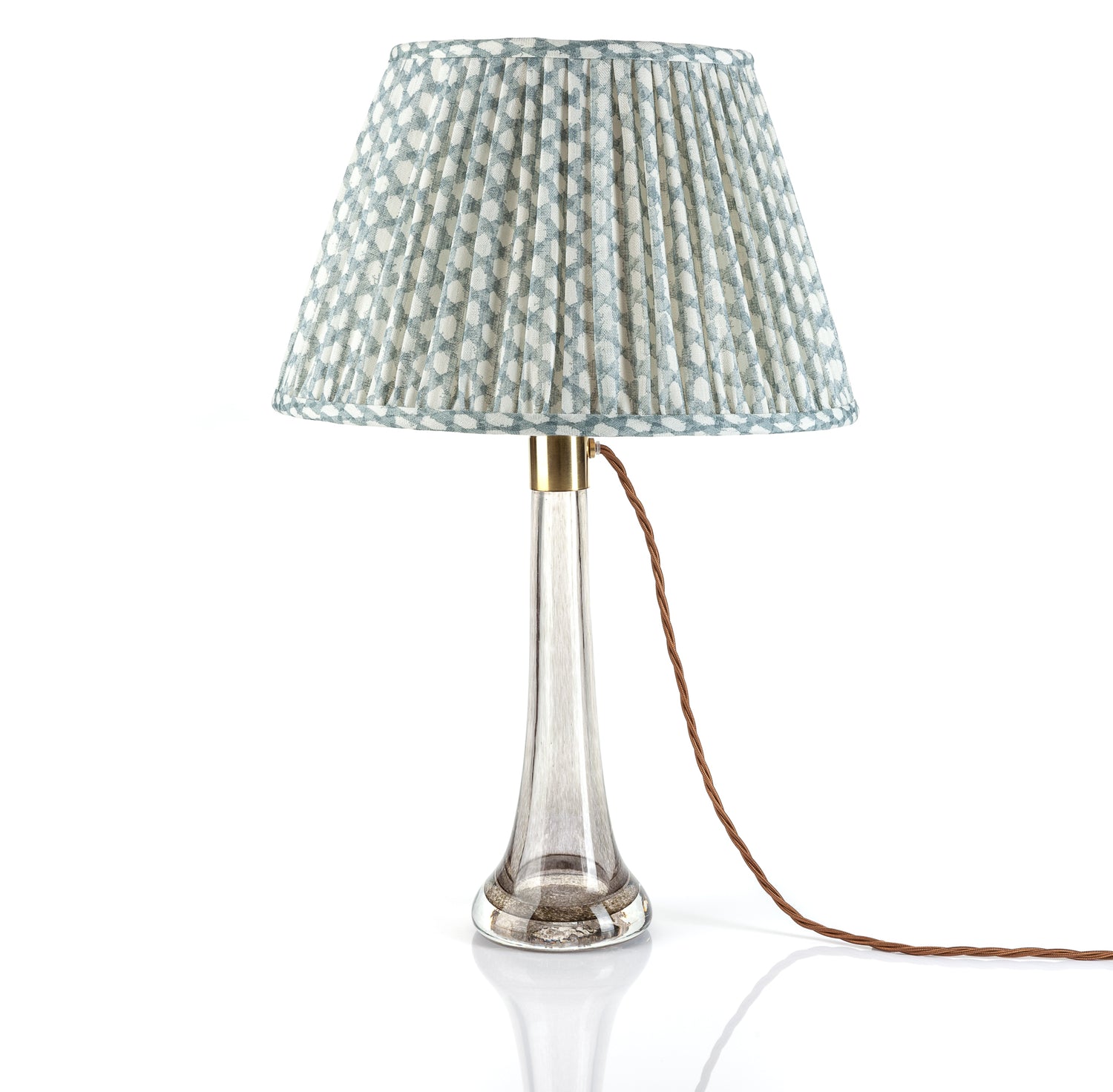 Table lamp with a patterned shade on a white background