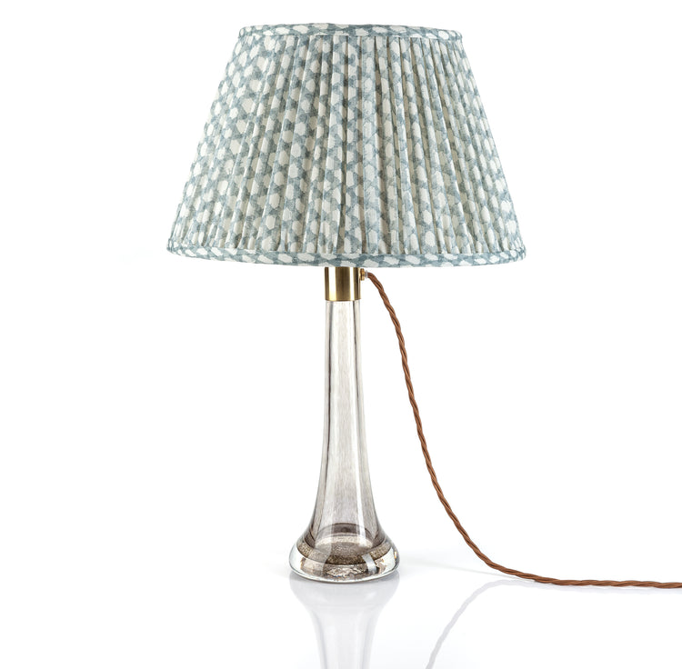 Table lamp with a patterned shade on a white background