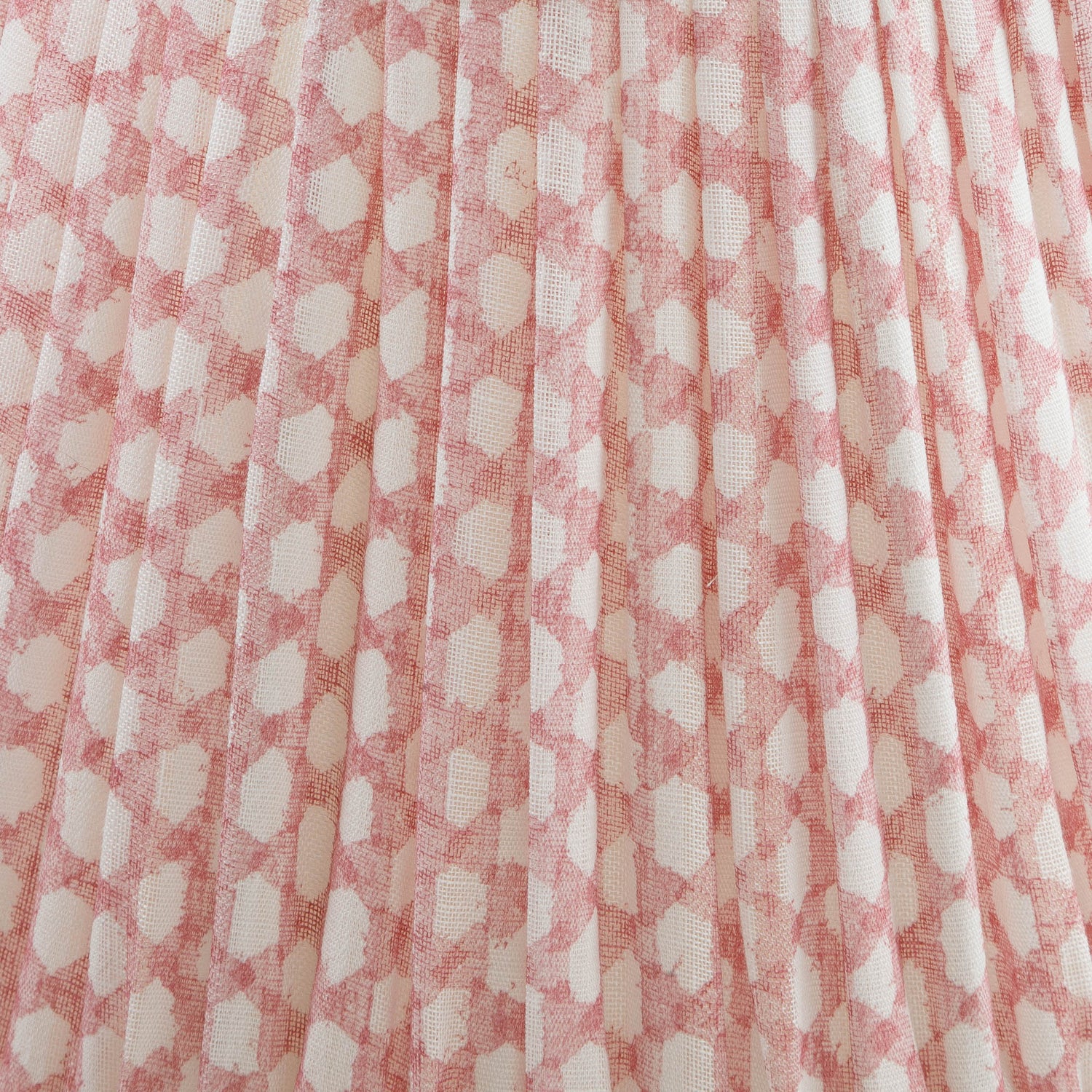 Close-up of a shade with a pink and white checkered fabric