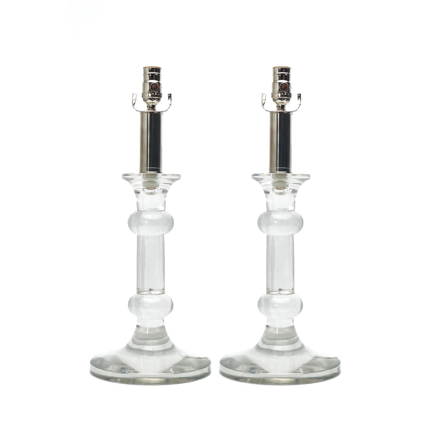 Two clear glass candlestick holders with silver metal sockets, shown side by side on a plain white background.