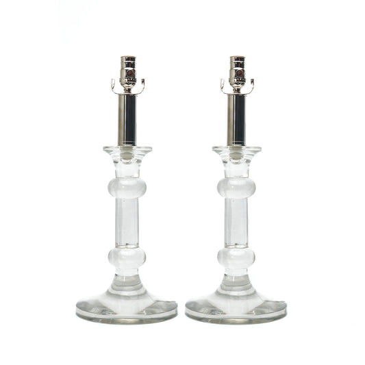 Two clear glass candlestick holders with silver metal sockets, shown side by side on a plain white background.