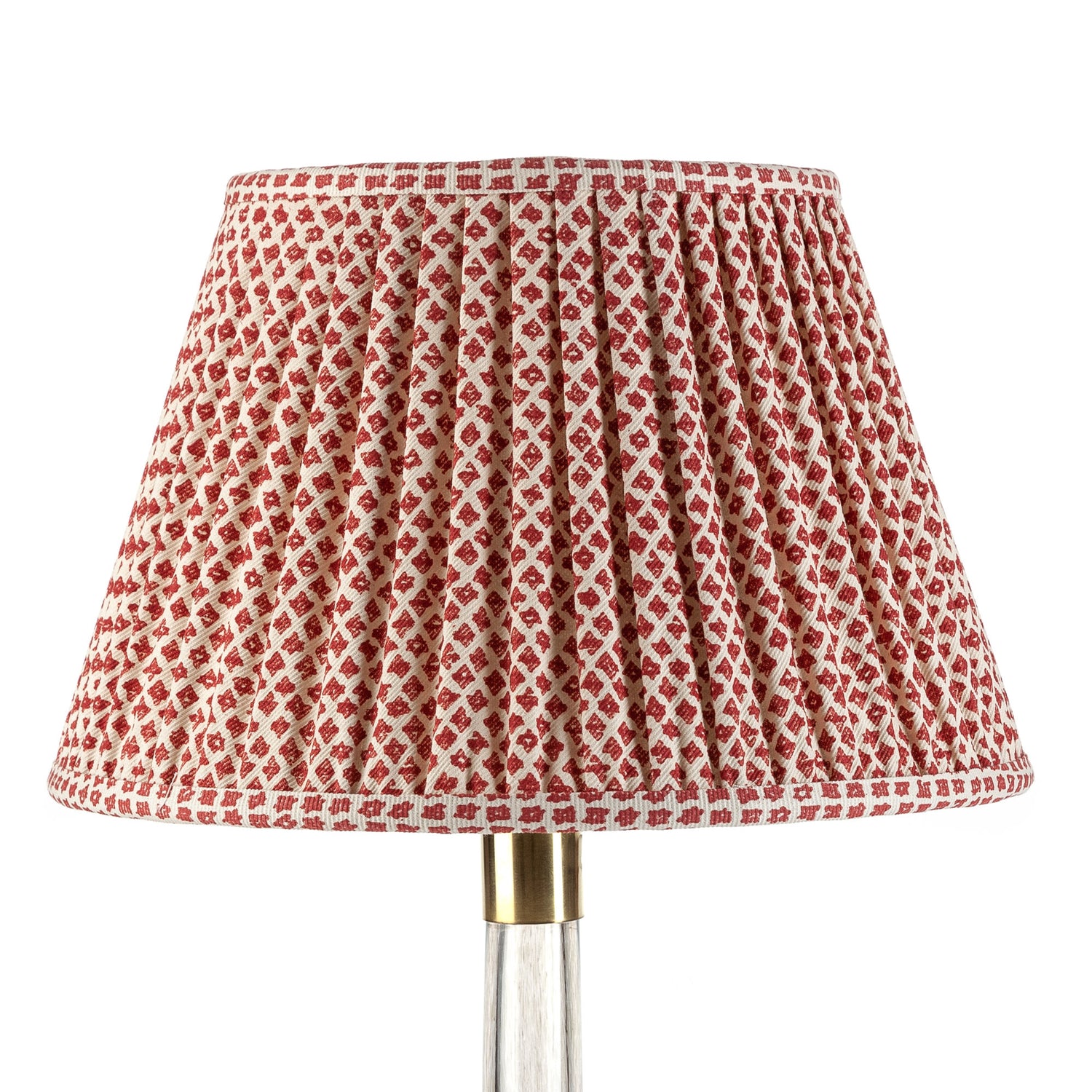 A red and white checkered lampshade with a gathered design on a lamp post.
